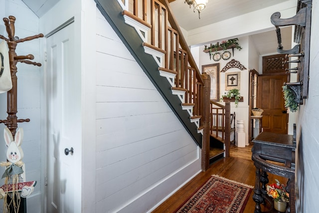 stairs featuring wood finished floors