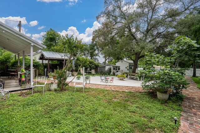view of yard featuring fence, a patio, a gazebo, and a wooden deck
