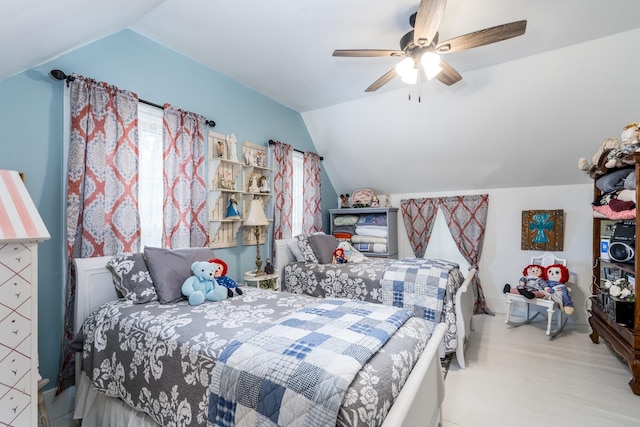 bedroom with wood finished floors, a ceiling fan, and lofted ceiling