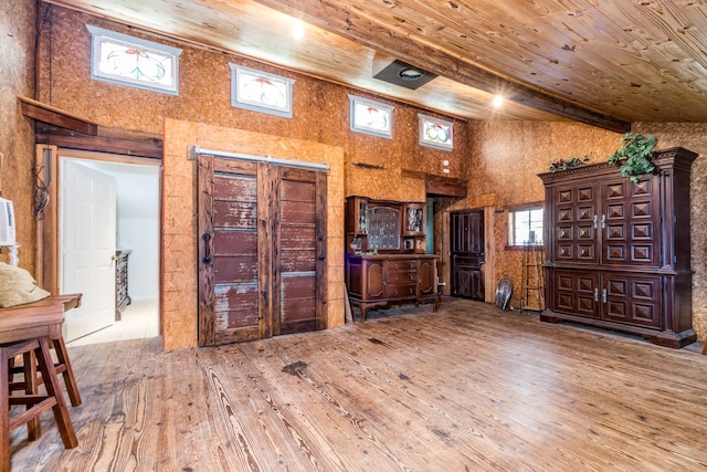 interior space featuring a high ceiling, hardwood / wood-style floors, wooden ceiling, and beamed ceiling