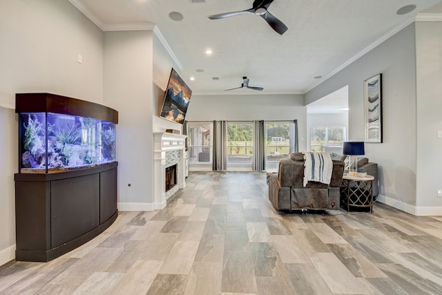 living area featuring ornamental molding, a fireplace, baseboards, ceiling fan, and recessed lighting