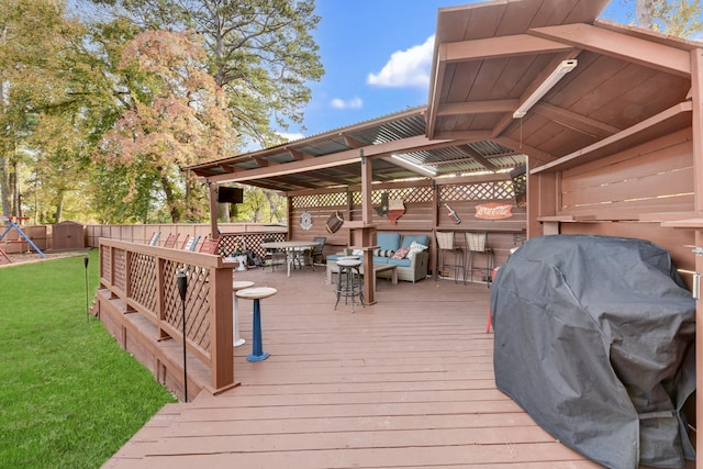 deck featuring fence, outdoor dining area, a shed, a yard, and an outbuilding