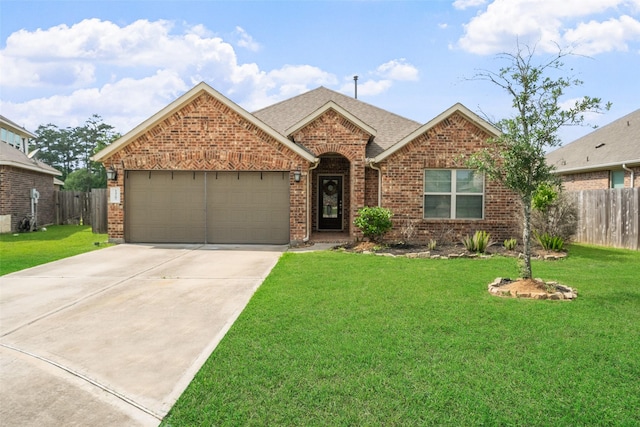 ranch-style house featuring fence, brick siding, a garage, a front yard, and driveway