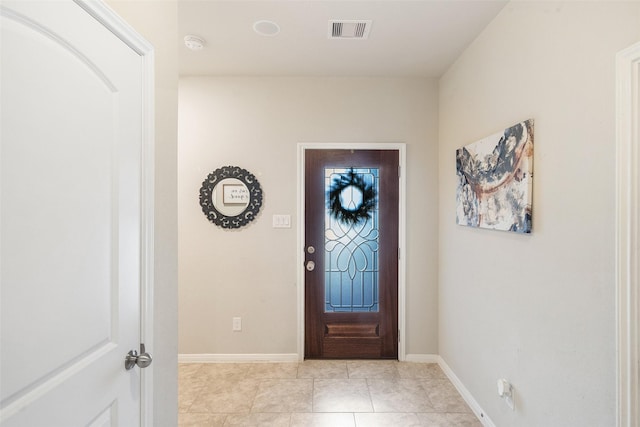 foyer featuring visible vents, baseboards, and light tile patterned floors