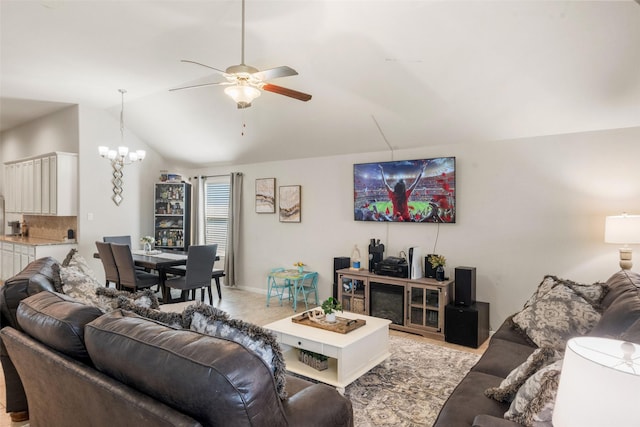 living area featuring ceiling fan with notable chandelier and vaulted ceiling