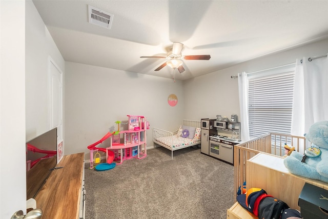 bedroom with carpet flooring, a ceiling fan, and visible vents