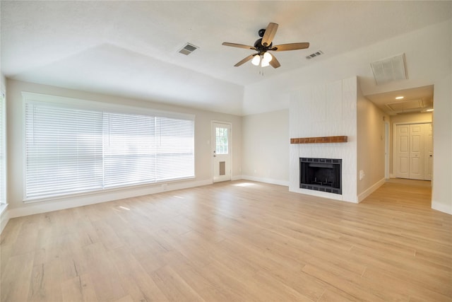 unfurnished living room with ceiling fan, visible vents, and attic access
