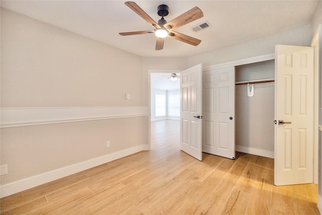 unfurnished bedroom featuring baseboards, light wood-style flooring, and visible vents