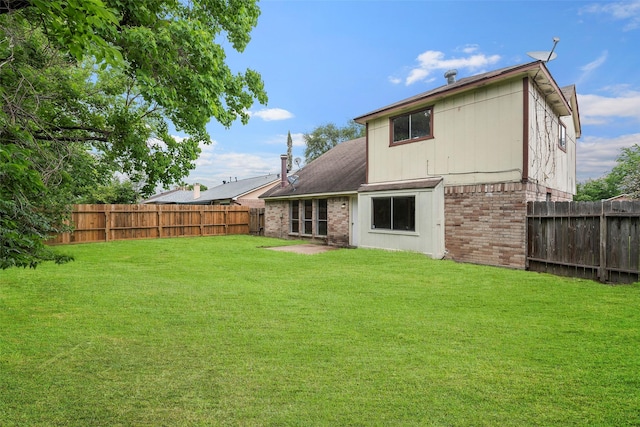 4027 Brookhead Trl, Houston, TX 77066 - back of house with a fenced backyard, a yard, and brick siding