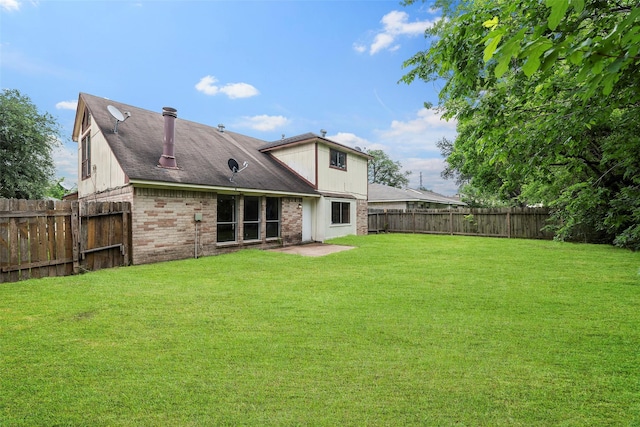 4027 Brookhead Trl, Houston, TX 77066 - rear view of property with a fenced backyard, a shingled roof, a yard, and brick siding