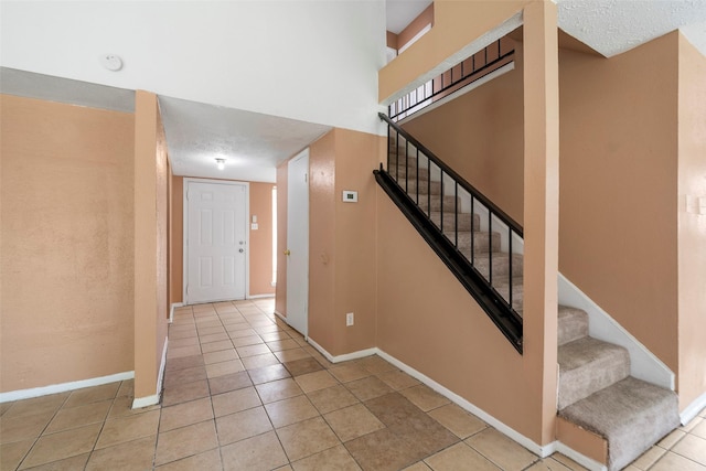 4027 Brookhead Trl, Houston, TX 77066 - stairs featuring baseboards, a textured ceiling, and tile patterned floors