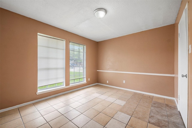 4027 Brookhead Trl, Houston, TX 77066 - unfurnished room featuring light tile patterned flooring, a textured ceiling, and baseboards