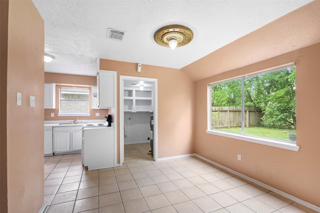 4027 Brookhead Trl, Houston, TX 77066 - kitchen featuring a textured ceiling, visible vents, a sink, light countertops, and white cabinets