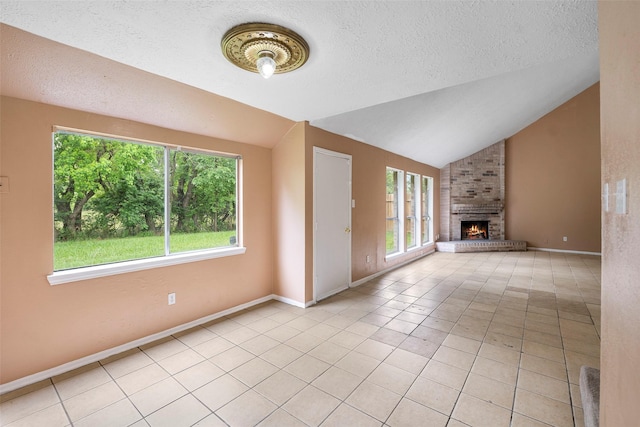 4027 Brookhead Trl, Houston, TX 77066 - unfurnished living room with a brick fireplace, lofted ceiling, a healthy amount of sunlight, and light tile patterned floors