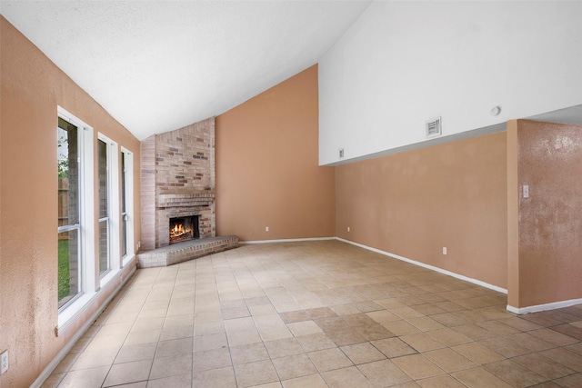 4027 Brookhead Trl, Houston, TX 77066 - unfurnished living room featuring visible vents, a fireplace, high vaulted ceiling, baseboards, and light tile patterned flooring