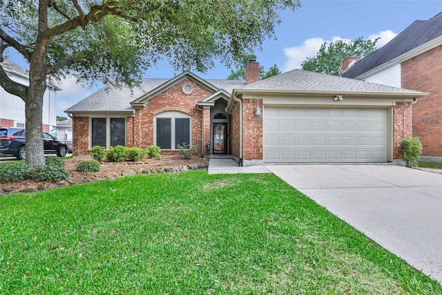 ranch-style house featuring an attached garage, concrete driveway, a front yard, and brick siding