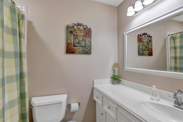bathroom with vanity, a shower with curtain, and toilet
