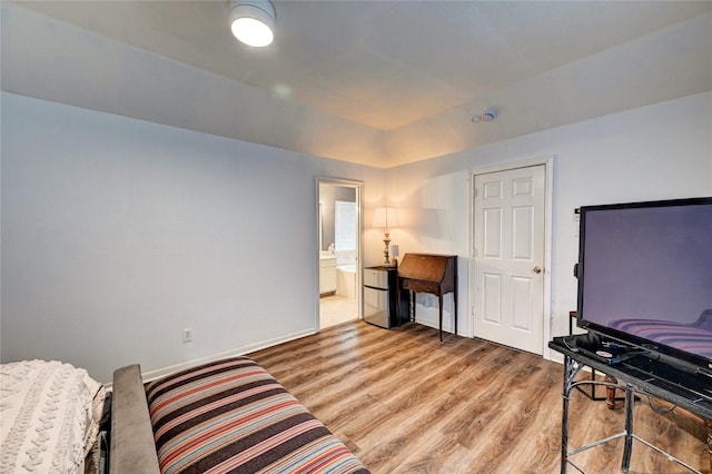 sitting room with baseboards and light wood finished floors