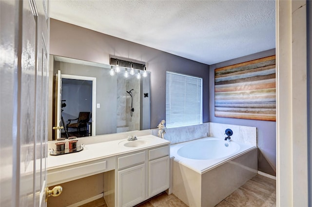 bathroom featuring a bath, a textured ceiling, tile patterned flooring, walk in shower, and vanity