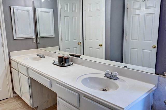 bathroom with double vanity, tile patterned floors, and a sink