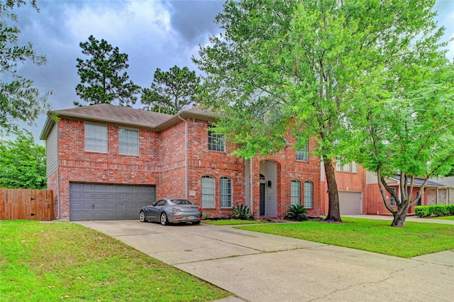 traditional home featuring brick siding, an attached garage, fence, and a front lawn