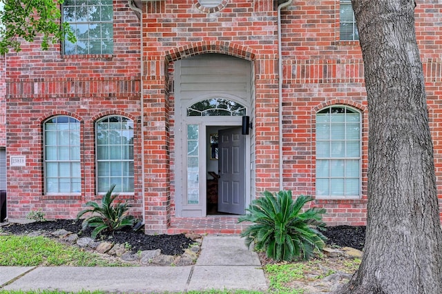 entrance to property with brick siding