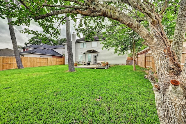 view of yard with a deck and a fenced backyard