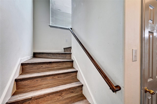 stairs featuring wood finished floors