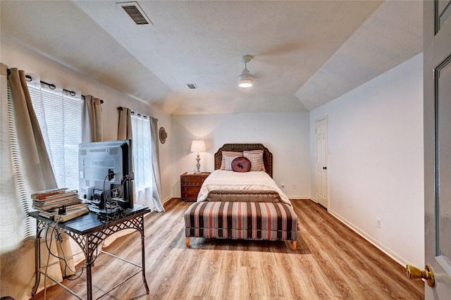 bedroom featuring a ceiling fan, baseboards, visible vents, and light wood finished floors