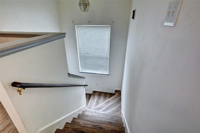 stairs with baseboards and wood finished floors