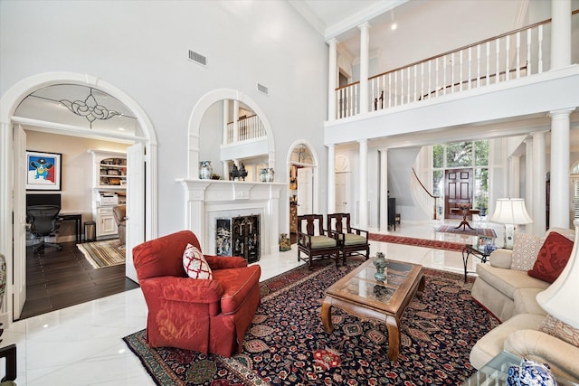 1623 Scenic Shore Dr, Kingwood, TX 77345 - living area with crown molding, a high ceiling, visible vents, and a fireplace