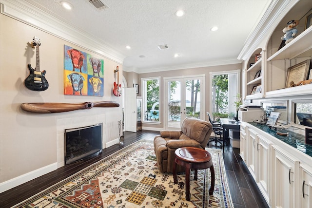 1623 Scenic Shore Dr, Kingwood, TX 77345 - interior space featuring a textured ceiling, dark wood-style flooring, a tile fireplace, and visible vents