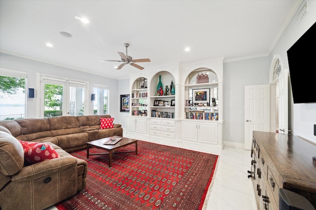 1623 Scenic Shore Dr, Kingwood, TX 77345 - living room featuring ornamental molding, ceiling fan, a healthy amount of sunlight, and built in shelves