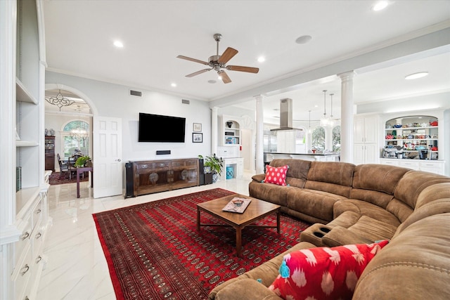 1623 Scenic Shore Dr, Kingwood, TX 77345 - living room featuring crown molding, ceiling fan, built in features, ornate columns, and visible vents