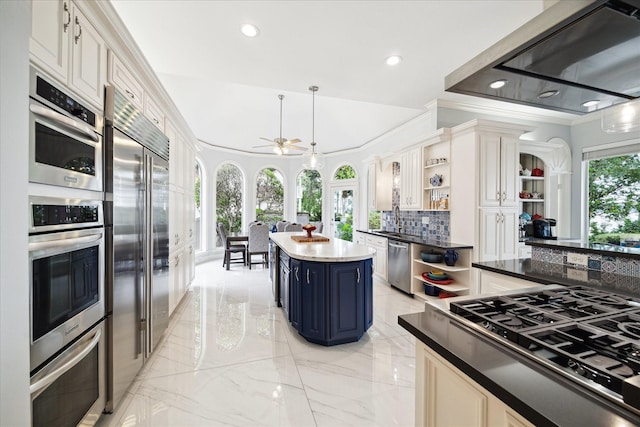 1623 Scenic Shore Dr, Kingwood, TX 77345 - kitchen featuring blue cabinets, appliances with stainless steel finishes, tasteful backsplash, open shelves, and marble finish floor