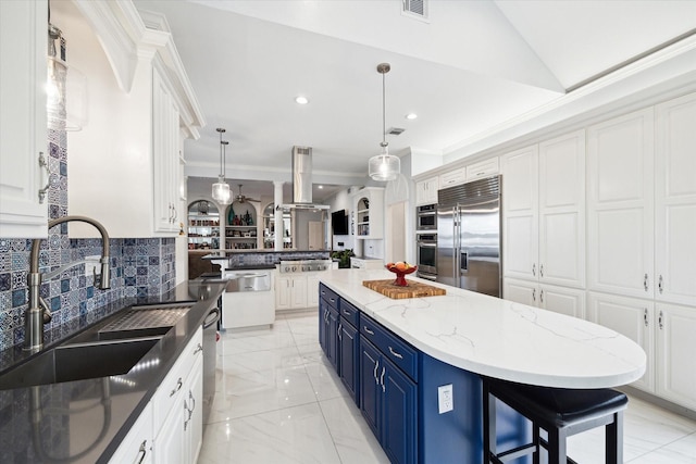 1623 Scenic Shore Dr, Kingwood, TX 77345 - kitchen featuring backsplash, blue cabinetry, appliances with stainless steel finishes, a sink, and white cabinets