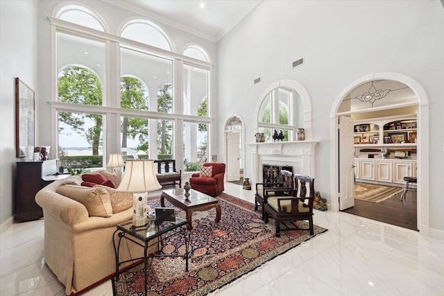 1623 Scenic Shore Dr, Kingwood, TX 77345 - living room featuring crown molding, a high ceiling, and a wealth of natural light