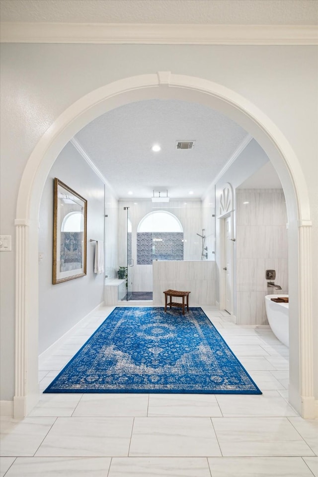 1623 Scenic Shore Dr, Kingwood, TX 77345 - hallway featuring tile patterned floors, ornamental molding, and visible vents