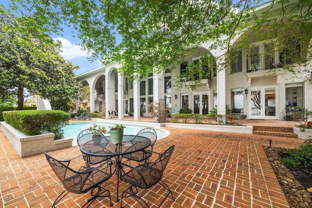 1623 Scenic Shore Dr, Kingwood, TX 77345 - view of patio with french doors and an outdoor pool