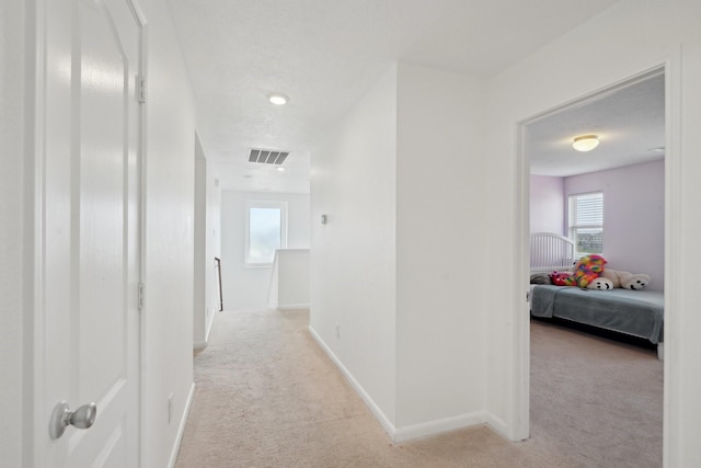 25404 Devonshire Knoll St, Katy, TX 77493 - hall featuring visible vents, baseboards, a wealth of natural light, and light carpet