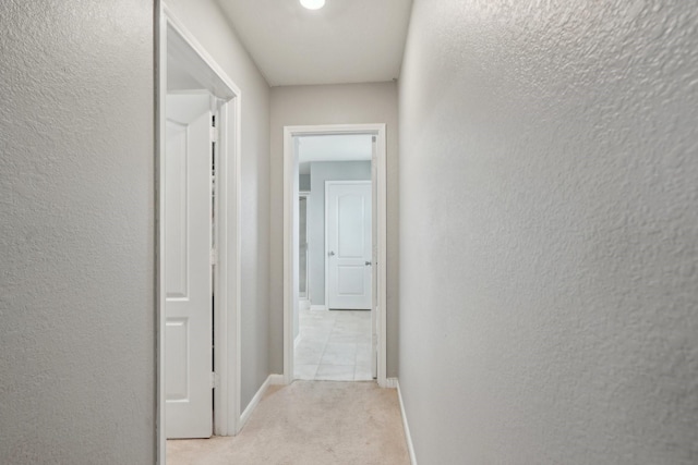 25404 Devonshire Knoll St, Katy, TX 77493 - hallway with baseboards, a textured wall, and carpet flooring