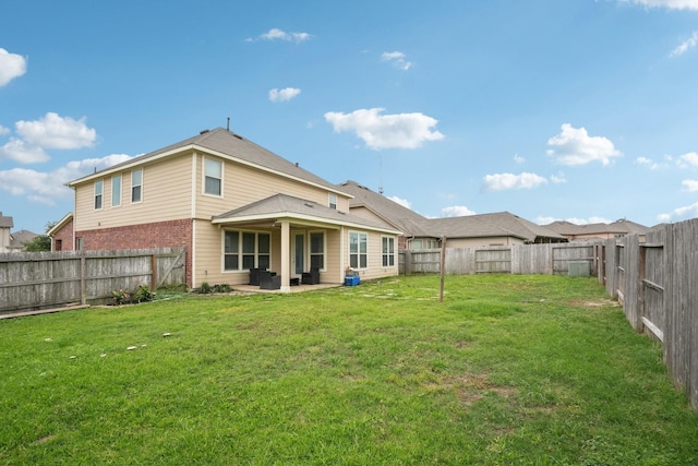 25404 Devonshire Knoll St, Katy, TX 77493 - rear view of property featuring a lawn, a fenced backyard, and a patio