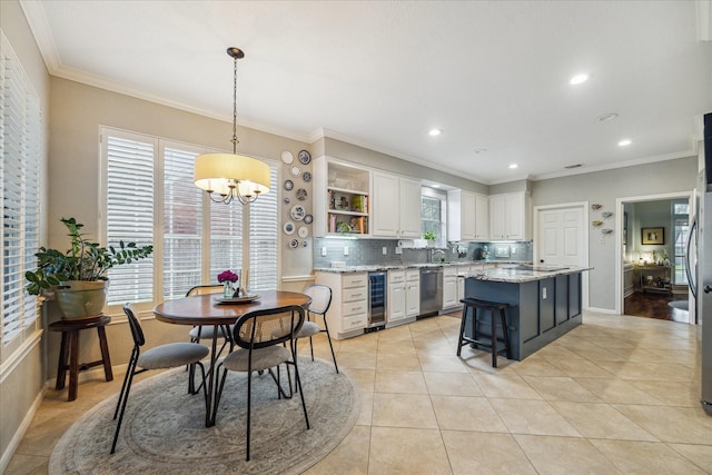 dining area with crown molding, wine cooler, light tile patterned floors, and a chandelier