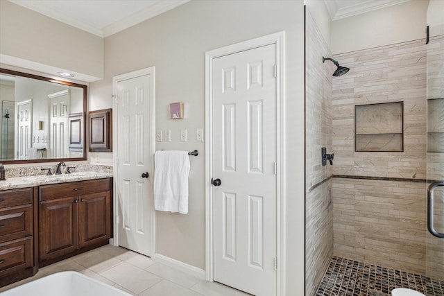 bathroom with vanity, tile patterned floors, crown molding, and a stall shower