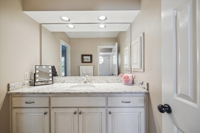 bathroom featuring vanity and recessed lighting