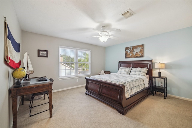 bedroom featuring baseboards, visible vents, light carpet, and ceiling fan