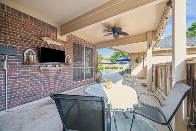 view of patio featuring outdoor dining area and a ceiling fan