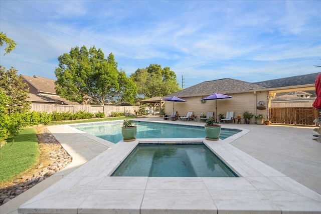 view of swimming pool with a patio, an in ground hot tub, a fenced in pool, and a fenced backyard