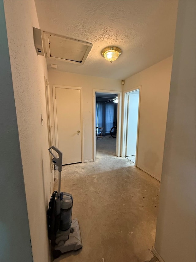 hall with a textured ceiling
