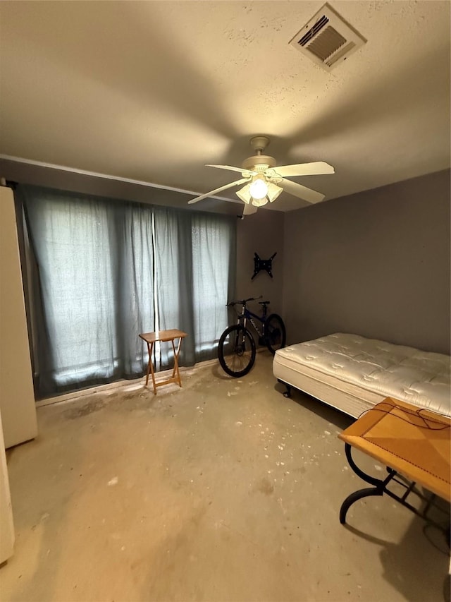 bedroom with a ceiling fan, concrete floors, and visible vents